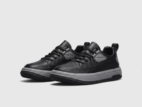 chunky sole leather casual sneakers in black, front 45-degree view of the pair on a light gray background