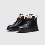chunky sole leather ankle boots in black, front 45-degree view of the pair on a light gray background