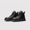 chunky sole leather ankle boots in black, front 45-degree view of the pair on a light gray background