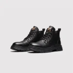 chunky sole leather ankle boots in black, front 45-degree view of the pair on a light gray background