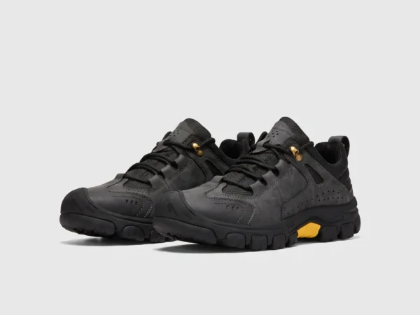 leather outdoor hiking sneakers in black, front 45-degree view of the pair on a light gray background