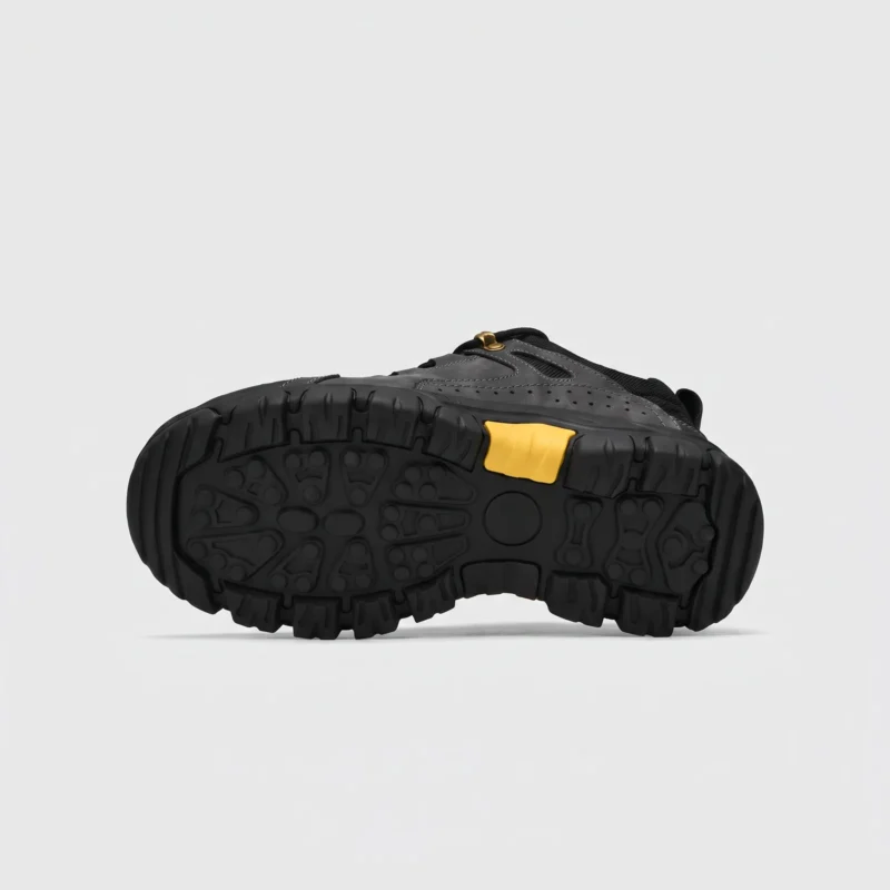 leather outdoor hiking sneakers in black, outsole tread view on a light gray background