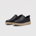 slip-on leather casual shoes in black, front 45-degree view of the pair on a light gray background
