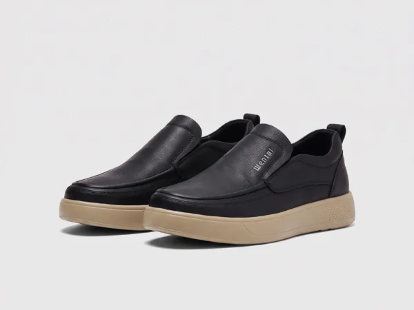 slip-on leather casual shoes in black, front 45-degree view of the pair on a light gray background