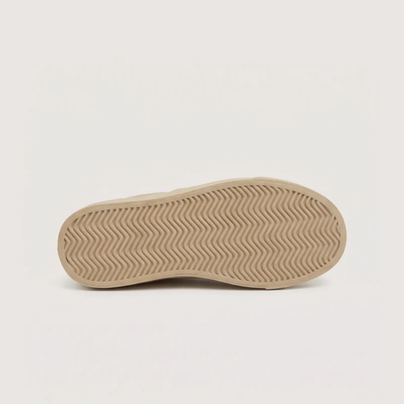 slip-on leather casual shoes in black, outsole tread view on a light gray background