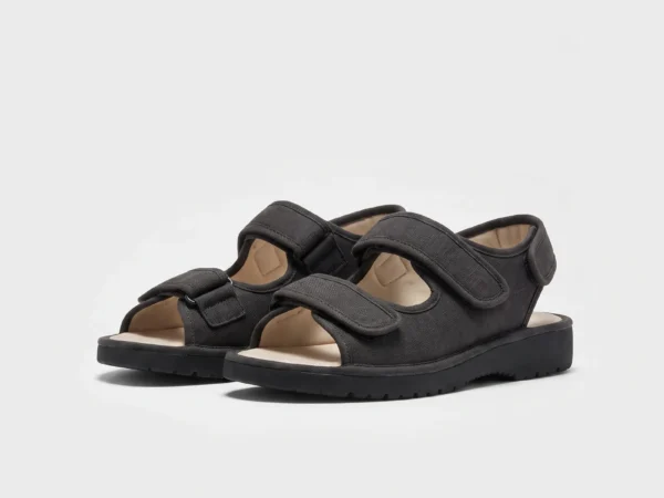 Pair of black AZEKA adjustable strap linen sandals, front 45 degree view, thick cushioned sole on light gray background