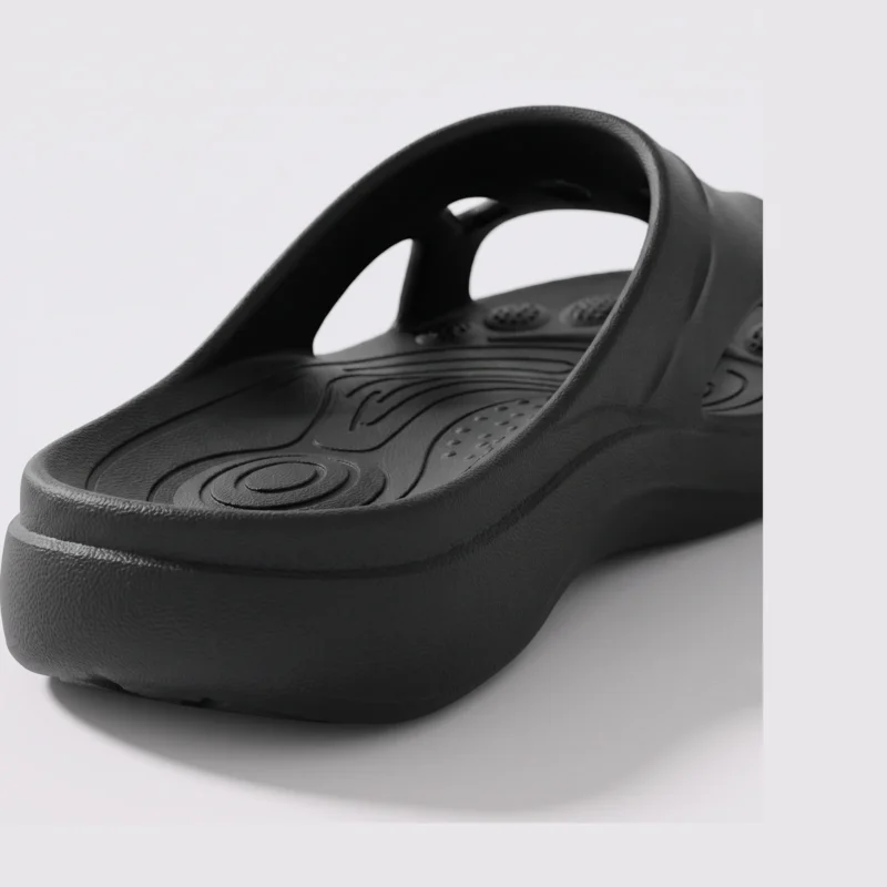 toe separator arch support slide sandals for women - open-toe cushioned platform in black, close-up view of the heel on a light gray background