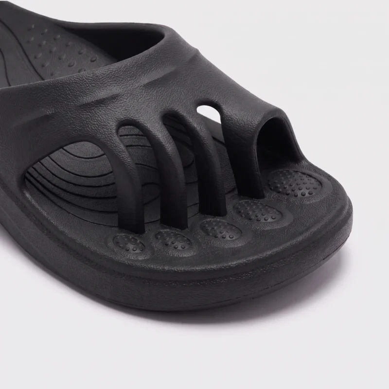 toe separator arch support slide sandals for women - open-toe cushioned platform in black, close-up view of the toe on a light gray background
