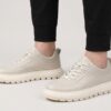 Menu2019s leather casual sneakers worn with casual trousers, side view