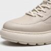 Toe close-up of beige menu2019s leather casual sneaker showing stitching