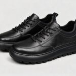Menu2019s leather casual sneakers in black, front 45 degree view
