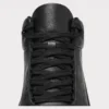 Woven lace and tongue detail of the black high-top leather boots