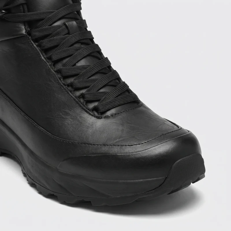 Toe detail of the black high-top leather boots showing the top-grain leather upper