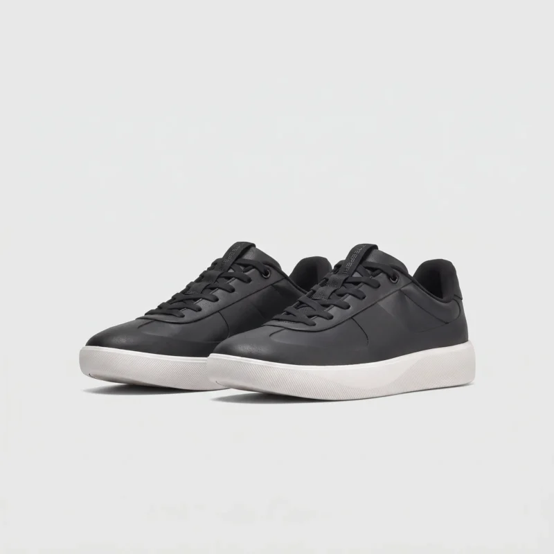 Retro German trainer sneakers in black, front 45 degree view