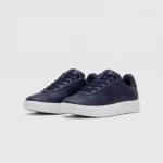 Retro German trainer sneakers in navy, front 45 degree view