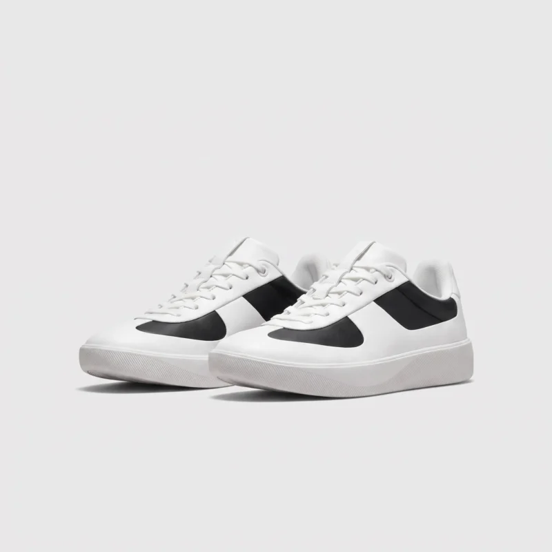 Retro German trainer sneakers in panda white and black, front 45 degree view