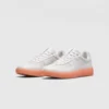 Retro German trainer sneakers in peach, front 45 degree view