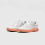 Retro German trainer sneakers in peach, front 45 degree view
