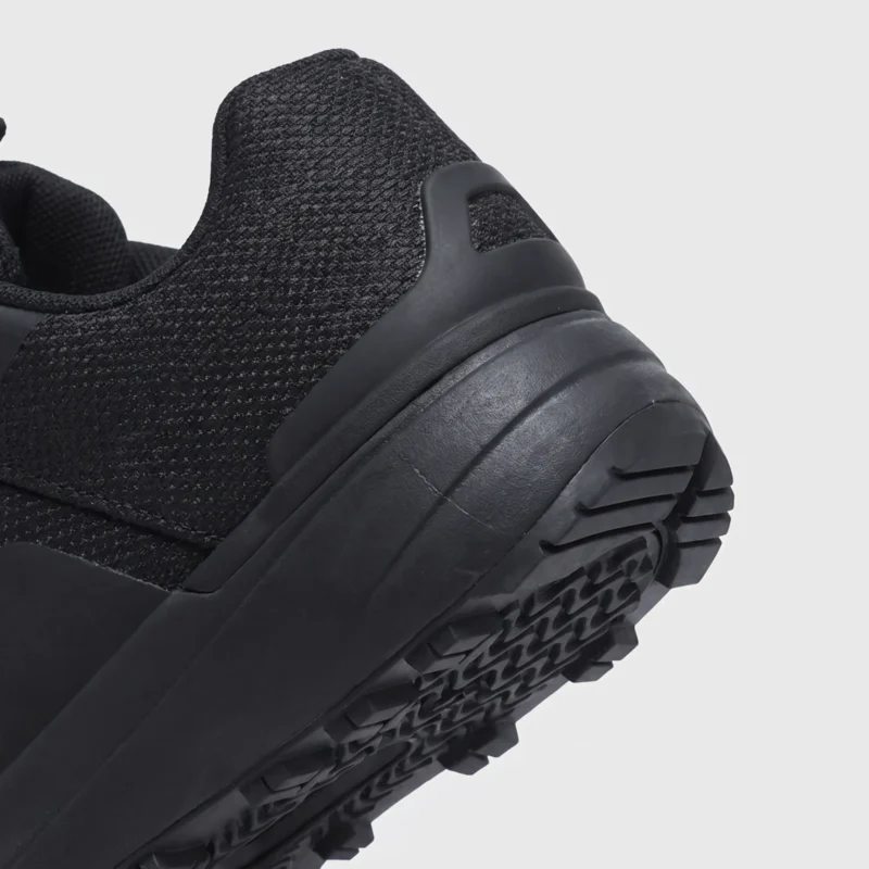 Heel detail of black waterproof trail running shoes showing reinforced support