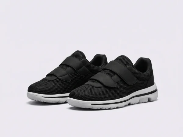 Black breathable wide fit walking shoes with hook-and-loop straps, front 45 degree view