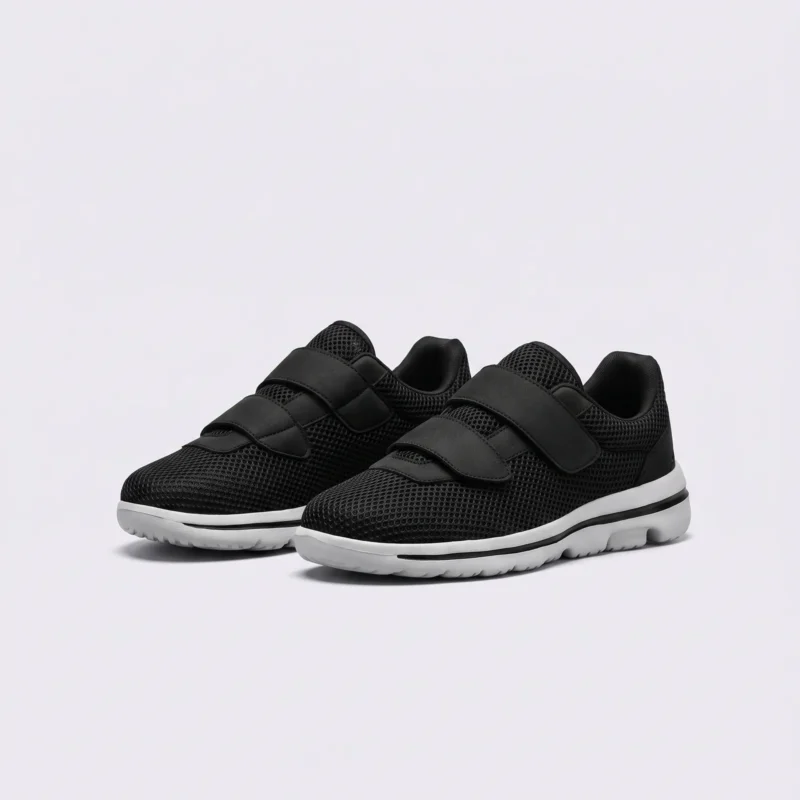 Black breathable wide fit walking shoes with hook-and-loop straps, front 45 degree view