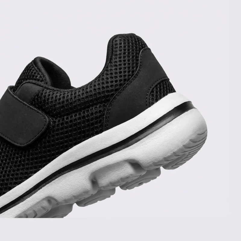 Close-up of the padded heel collar of black wide fit walking shoes