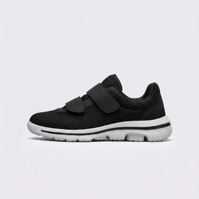 Side profile of black breathable wide fit walking shoes with double hook-and-loop straps