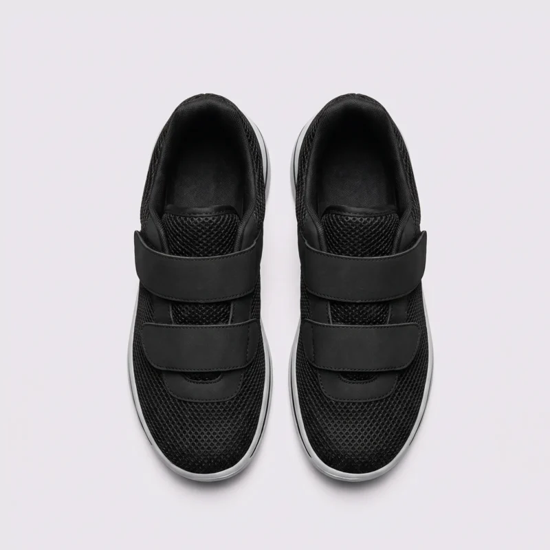 Top view of a pair of black wide fit walking shoes showing dual hook-and-loop straps