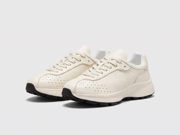 cream leather chunky lace-up dad sneakers in cream, front 45-degree view of the pair on a light gray background