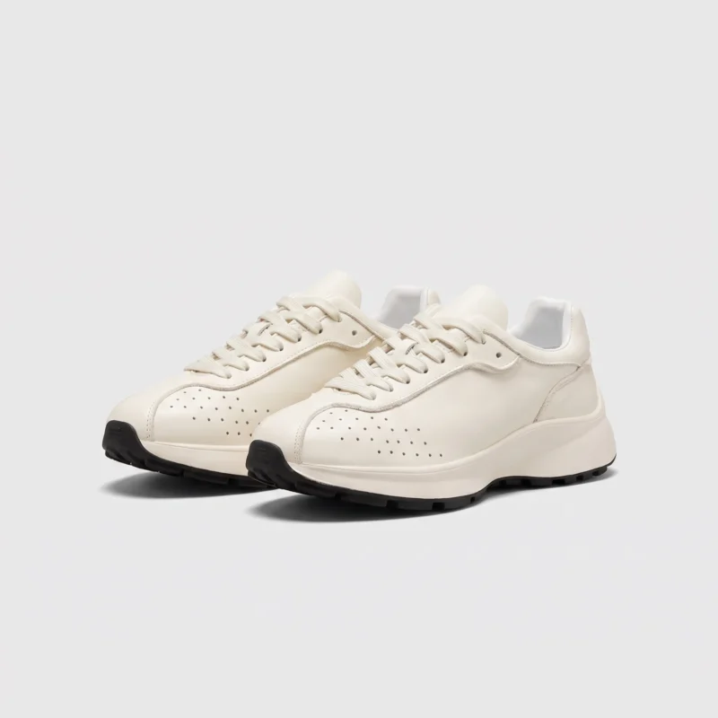 cream leather chunky lace-up dad sneakers in cream, front 45-degree view of the pair on a light gray background