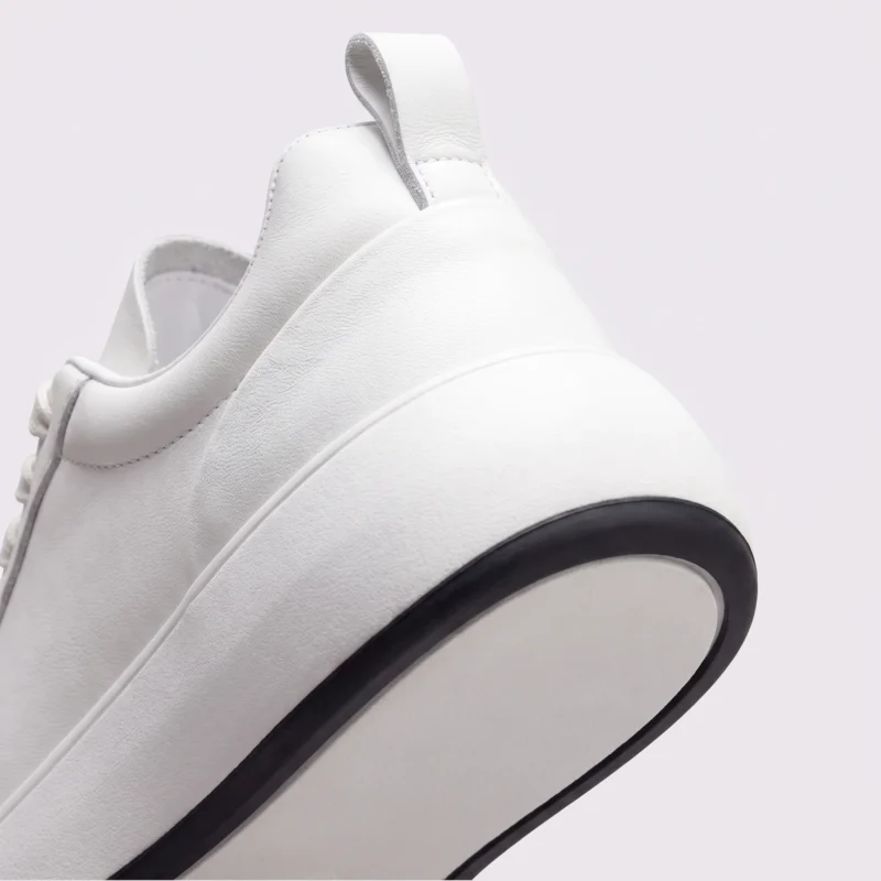 cream leather chunky lace-up dad sneakers in cream, close-up view of the heel on a light gray background
