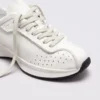 cream leather chunky lace-up dad sneakers in cream, close-up view of the toe on a light gray background