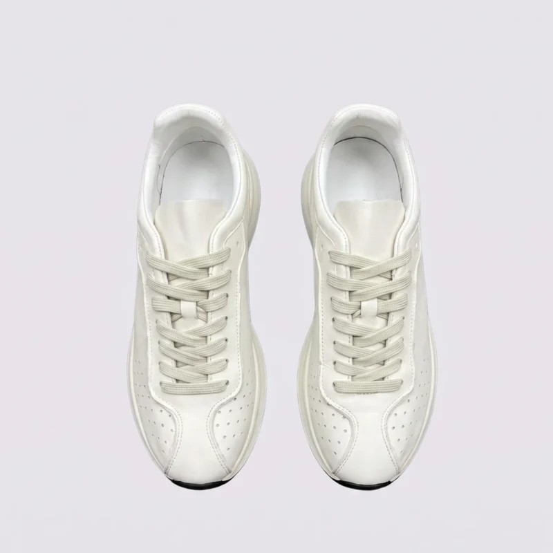 cream leather chunky lace-up dad sneakers in cream, top-down view of the pair on a light gray background