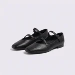 Pair of black AZEKA French-retro single-strap Mary Jane flats, soft flat sole, front 45 degree view on light gray background