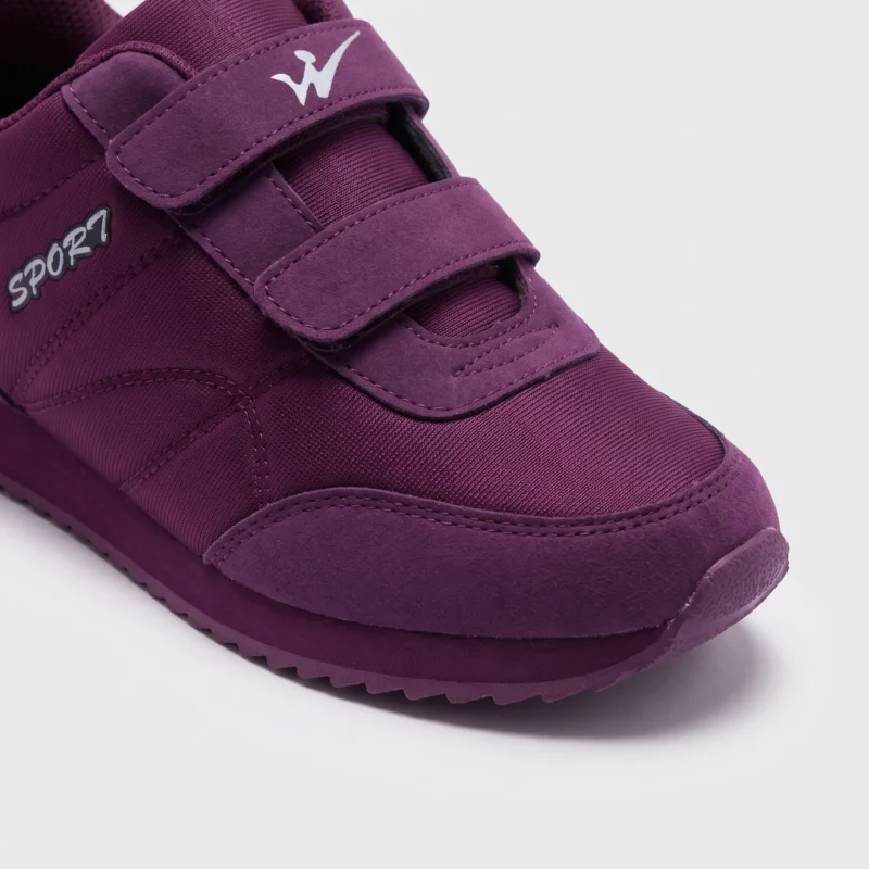 cushioned walking sneakers hook-and-loop slip-on non-slip comfort shoes, close-up view of the toe on a light gray background