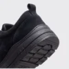 Close-up of the heel and grippy tread outsole edge of a black AZEKA fleece-lined slip-on winter shoe with pull tab