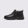 Side profile of a black AZEKA fleece-lined slip-on winter shoe showing elastic gore panel and plush collar lining
