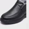 Close-up of the rounded toe stitching and black upper of an AZEKA fleece-lined slip-on winter shoe