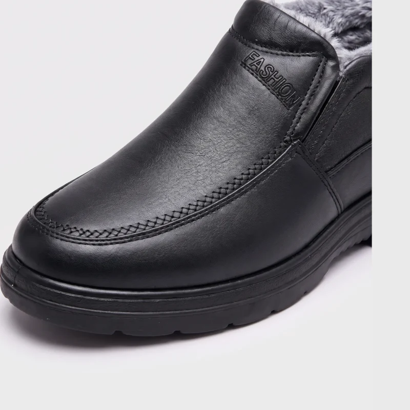 Close-up of the rounded toe stitching and black upper of an AZEKA fleece-lined slip-on winter shoe