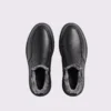 Top-down view of a pair of black AZEKA fleece-lined slip-on winter shoes showing rounded toe and soft gray fleece lining