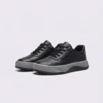 genuine leather casual sneakers breathable chunky sole in black, front 45-degree view of the pair on a light gray background
