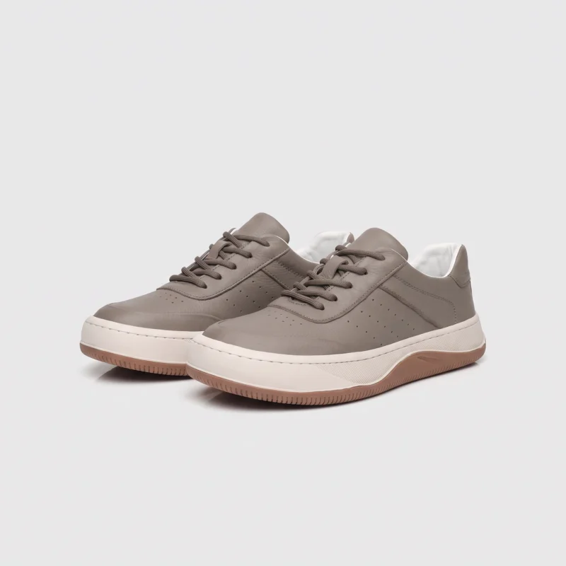 genuine leather casual sneakers breathable chunky sole in gray, front 45-degree view of the pair on a light gray background