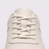 genuine leather casual sneakers breathable chunky sole in white, close-up view of the closure on a light gray background