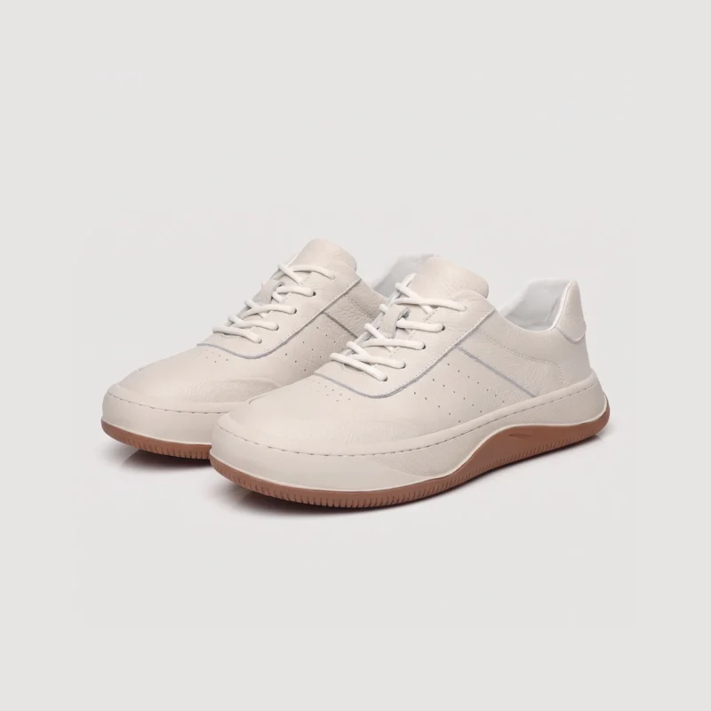 genuine leather casual sneakers breathable chunky sole in white, front 45-degree view of the pair on a light gray background