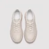 genuine leather casual sneakers breathable chunky sole in white, top-down view of the pair on a light gray background