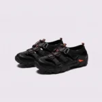 cut-out sport sandals - closed toe with hook-and-loop straps and a lugged rubber sole in black, front 45-degree view of the pair on a light gray background