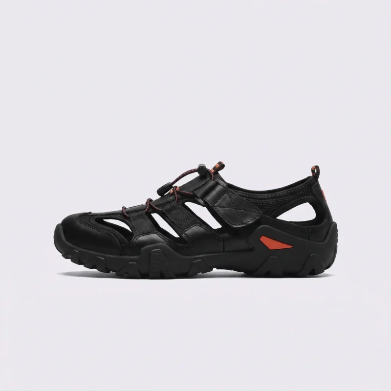 cut-out sport sandals - closed toe with hook-and-loop straps and a lugged rubber sole in black, left side profile view on a light gray background