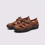 cut-out sport sandals - closed toe with hook-and-loop straps and a lugged rubber sole in brown, front 45-degree view of the pair on a light gray background