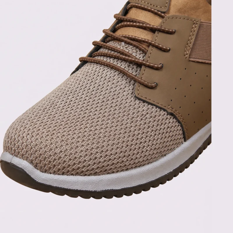 men's perforated mesh lace-up sneakers - thin summer walking shoes with a flex-groove sole in brown, close-up view of the toe on a light gray background
