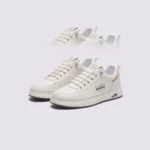 men's perforated slip-on sneakers - breathable knit casual walking shoes with cushioned sole in beige, front 45-degree view of the pair on a light gray background